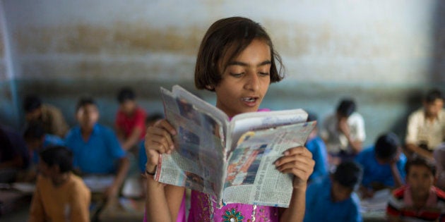 INDIA - MARCH 17: Indian girl reading aloud during English lesson at Rajyakaiya School in Narlai village, Rajasthan, Northern India (Photo by Tim Graham/Getty Images)