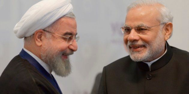 Iran's President Hassan Rouhani, left, smiles as Indian Prime Minister Narendra Modi speaks to him during the summit in Ufa, Russia, Thursday, July 9, 2015. Ufa hosts SOC (Shanghai Cooperation Organization) and BRICS (Brazil, Russia, India, China and South Africa) summits. (Host photo agency/RIA Novosti Pool Photo via AP)