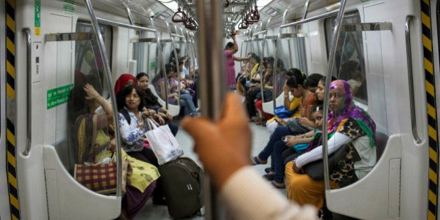 Indian women travel inside a Women Only metro train compartment in New Delhi, India, Thursday, June 26, 2014. Phase III of the Delhi metro, the Mandi House to Central Secretariat, which covers a distance of 3.2 kilometers (2 miles) opened to the public Thursday and is estimated to benefit 70,000 commuters. (AP Photo/Tsering Topgyal)