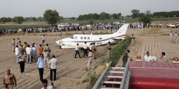 Security personnel secure the site where an air-ambulance, carrying seven passengers, crash landed after losing both its engines, according to local media, in New Delhi, India May 24, 2016. REUTERS/Anindito Mukherjee