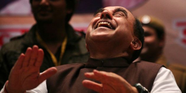 Subramanian Swamy, an opposition politician who brought the petition to revoke the telecoms licences issued in 2008, laughs during a seminar against corruption in New Delhi February 4, 2012. India's beleaguered government won some rare relief on Saturday when a court threw out a corruption case against one its top ministers ahead of crucial state elections next week. The court dismissed a petition accusing Home Minister Palaniappan Chidambaram of signing off on the sale of telecoms licenses at below-market prices that may have cost the government up to $36 billion in lost revenues. REUTERS/Parivartan Sharma (INDIA - Tags: POLITICS BUSINESS TELECOMS)
