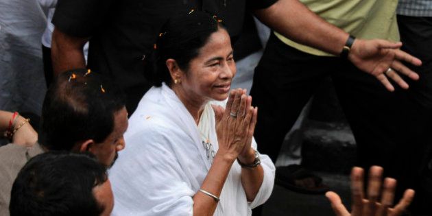 Trinamul Congress leader Mamata Banerjee greets people with folded hands as she walks in a road show ahead of the West Bengal state Assembly elections, in Kolkata, India, Sunday, April 24, 2016. The six-phased poll started on April 4 and is scheduled to end on May 5. Results are expected on May 19. (AP Photo/ Bikas Das)