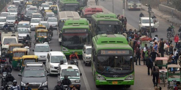 Indian commuters board Delhi Transport Corporation (DTC) buses in New Delhi on January 15, 2016. New Delhi on January 15 wrapped up a trial of draconian driving restrictions that has taken around a million cars off the roads and seen even judges and diplomats carpool, but made little obvious difference to air quality in the world's most polluted capital. Air quality levels remained 'very unhealthy' on January 15, the final day of the two-week experiment in allowing private cars on the roads only on alternate days. AFP PHOTO / PRAKASH SINGH / AFP / PRAKASH SINGH (Photo credit should read PRAKASH SINGH/AFP/Getty Images)