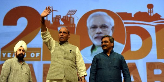 NEW DELHI, INDIA - MAY 27: Union Home Minister Rajnath Singh, with Delhi BJP President Satish Upadhyay arrives at the Vikas Parv Function to celebrate the completion of second successful year of the Central Government headed by Prime Minister Narendra Modi at Siri Fort Auditorium on May 27, 2016 in New Delhi, India.( Photo by Sonu Mehta/Hindustan Times via Getty Images)