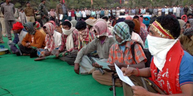 Naxalites with their faces covered sit as they await to surrender before the Chief Minister of Chhatisgarh State, Dr.Raman Singh, unseen, in Raipur,India, Wednesday, Jan.3, 2007.79 Naxals surrendered according to an agency. (AP Photo)