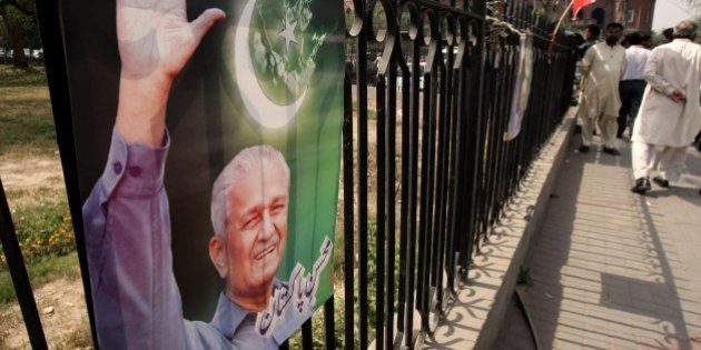 A poster of Pakistani disgraced nuclear scientist A.Q. Khan, also known as Abdul Qadeer Khan, is seen on a grill hanged by his supporter in Lahore Pakistan on Monday, March 29, 2010. A Pakistan court has maintained restrictions on Khan who allegedly leaked atomic weapons secrets to Iran, North Korea and Libya. The court ruled Khan was not allowed to talk about nuclear weapons technology and must inform security agencies before he leaves his house so they can accompany him where ever he goes, Khan's lawyer said. (AP Photo/K.M. Chaudary)