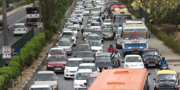 Indian commuters travel in a traffic jam on their way to Gurgaon from New Delhi on May 3, 2016. The Indian capital is witnessing massive jams for a second day as taxi drivers protest the ban on diesel cab after India's Supreme court order banning diesel cabs from plying the roads of the world's most polluted capital. The ban impacted some 27,000 diesel taxis registered in Delhi, including app-based cab operators Ola and Uber. / AFP / MONEY SHARMA (Photo credit should read MONEY SHARMA/AFP/Getty Images)