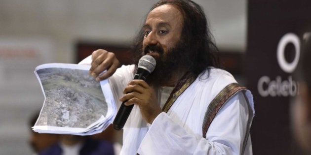 NEW DELHI, INDIA - MARCH 13: Spiritual Guru Sri Sri Ravi Shankar addressing a press conference during the World Culture Festival organised by the Art of Living Foundation headed by Sri Sri Ravi Shankar, on March 13, 2016 in New Delhi, India. The mega event witness artists, musicians and dancers from across the globe participating with utmost zest and enthusiasm. The 3-day mega event was embroiled in controversy till the very last moment before the National Green Tribunal gave it a green signal. But not before the organisers submitted Rs. 25 lakh, part of the Rs. 5 crore fine imposed by the green tribunal. (Photo by Virendra Singh Gosain/Hindustan Times via Getty Images)