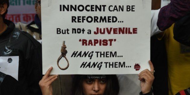 An Indian protester holds a placard during a demonstration against the release of a juvenile rapist in New Delhi on December 21, 2015. India's Supreme Court December 21, 2015 rejected an appeal against the release of the youngest convict in an infamous fatal gang-rape, sparking fury from the victim's parents who said the ruling was a betrayal of women. AFP PHOTO / Money SHARMA / AFP / MONEY SHARMA (Photo credit should read MONEY SHARMA/AFP/Getty Images)