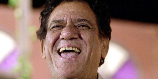 Bollywood actor Om Puri laughs after being felicitated at a function to mark the 57th anniversary of Indias Independence in Bombay, India, Sunday, Aug.15, 2004. Puri was awarded Order of the British Empire by Queen Elizabeth II for his outstanding services to the British film industry earlier this year. (AP Photo/Rajesh Nirgude)