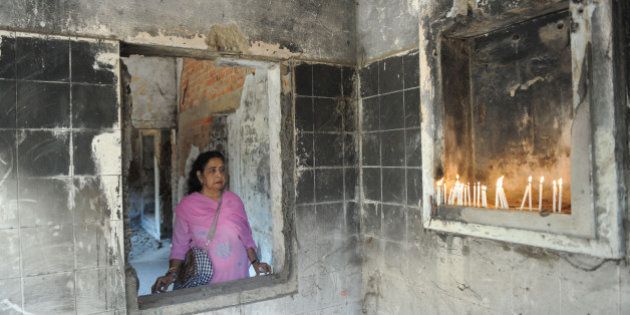 Suraiya Ankleshwaria looks on as she and others pay homage to those killed at Gulbarg Society following the February 2002 Godhra train incident, which sparked communal riots that year, on the ninth anniversary of the incident in Ahmedabad on February 28, 2011. A total of 69 people were killed in the Gulberg Society carnage, including former Congress Member of Parliament Ehsan Jafri on February 28, 2002. The aftermath of the Godhra Train carnage resulted in widespread communal riots across Gujarat where more than 2,000 were killed. A Special Court has reserved the pronouncement of quantum of punishment to the 31 convicted in the Godhra Train Carnage incident till March 1. AFP PHOTO / Sam PANTHAKY (Photo credit should read SAM PANTHAKY/AFP/Getty Images)