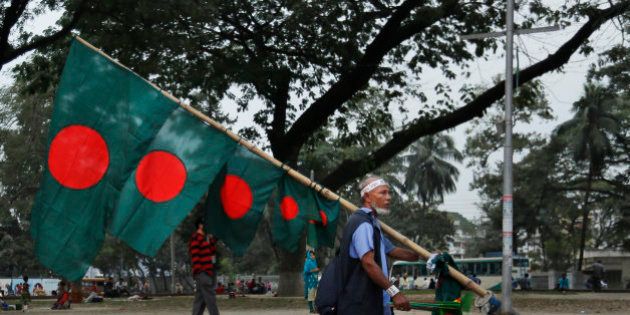 A street vendor carries Bangladeshi flag for sale ahead of Victory Day in Dhaka, Bangladesh, Monday, Dec. 14, 2015. The Victory Day celebrated on December 16 marks the anniversary of Bangladesh' victory in the India-aided war victory against Pakistan. (AP Photo/A.M. Ahad)