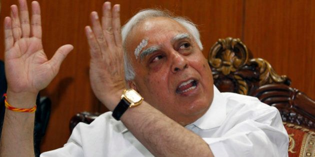 India's Telecoms Minister Kapil Sibal gestures during a news conference in New Delhi April 11, 2011. Merger and acquisition guidelines in India's crowded telecoms sector need to be liberal, Sibal said on Monday. India is overhauling its decade-old telecoms policy in a bid to make the world's second-largest market for mobile phone services more transparent after the sector was hit by a multi-billion-dollar telecoms licensing scandal. REUTERS/Adnan Abidi (INDIA - Tags: BUSINESS POLITICS)
