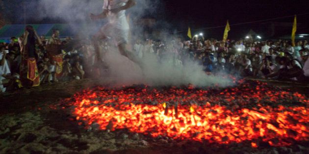A Spirit medium walks across burning coals at the Phuket Vegetarian Festival in Phuket Town, Thailand. The event is held over a nine-day period in October, celebrating the Chinese community's belief that abstinence from meat and various stimulants during the ninth lunar month of the Chinese calendar will help them obtain good health and peace of mind.