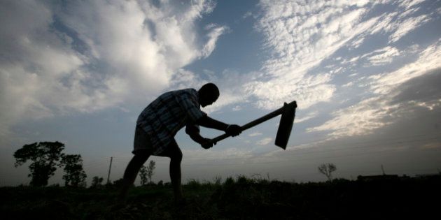 A farmer is silhouetted as he works on a piece of arid land on the outskirts of Amritsar, India, Wednesday, June 24, 2009. India's monsoon rainfall, the main source of irrigation for the country's 235 million farmers, may be below normal this year, the government said on Wednesday. (AP Photo/Altaf Qadri)
