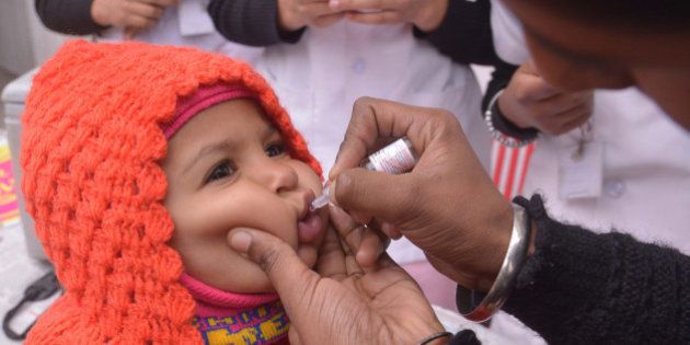 An Indian health worker administers polio drops to a child during a polio immunisation programme in Amritsar on January 17, 2016. During the Pulse Polio programme for 2016, around 17.4 crore children under the age of five years will be given polio drops. AFP PHOTO/ NARINDER NANU / AFP / NARINDER NANU (Photo credit should read NARINDER NANU/AFP/Getty Images)