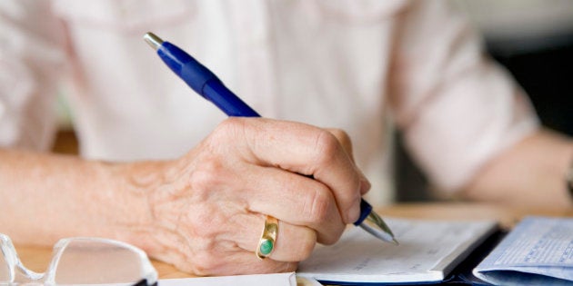 Woman writing on a diary