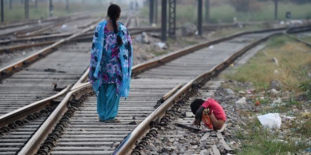 An Indian child defecates in an open near a railway track on International Toilet Day in New Delhi on November 19, 2015. About 1.1 billion people around the world defecate in the open because they do not have access to proper sanitation facilities. / AFP / SAJJAD HUSSAIN (Photo credit should read SAJJAD HUSSAIN/AFP/Getty Images)