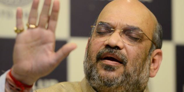 Amit Shah, national president of the ruling Bharatiya Janata Party (BJP), gestures as he answers questions during a press conference in Kolkata on March 29, 2016. / AFP / Dibyangshu SARKAR (Photo credit should read DIBYANGSHU SARKAR/AFP/Getty Images)