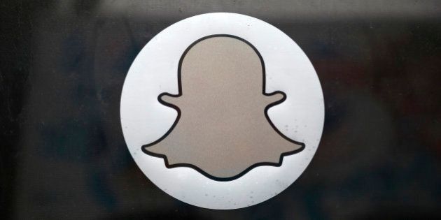 The Snapchat logo is seen on the door of their headquarters in Venice, Los Angeles, California October 13, 2014. Mobile messaging company Snapchat blamed third-party software apps for possible security lapses that may have led to its users' private photos being at risk of online publication by hackers. A file containing at least 100,000 Snapchat photos has been collected by hackers who were preparing to publish them online, according to a report on the Business Insider blog. Snapchat lets users send photos and videos that disappear in seconds. REUTERS/Lucy Nicholson (UNITED STATES - Tags: BUSINESS SOCIETY SCIENCE TECHNOLOGY TELECOMS LOGO)