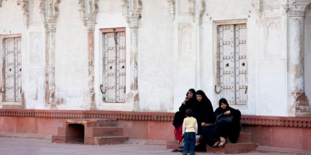 INDIA - MARCH 05: Muslim family group at Khas Mahal Palace built 17th Century by Mughal Shah Jehan for his daughters inside Agra Fort, India (Photo by Tim Graham/Getty Images)