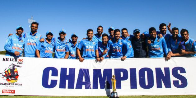 India's players pose with the ODI series trophy after winning the third and final ODI cricket match between India and Zimbabwe at the Harare Sports Club, on June 15, 2016. India, powered by seamer Jasprit Bumrah's 4-22, crushed Zimbabwe by 10 wickets for a one-day international series whitewash at Harare Sports Club. / AFP / Jekesai Njikizana (Photo credit should read JEKESAI NJIKIZANA/AFP/Getty Images)