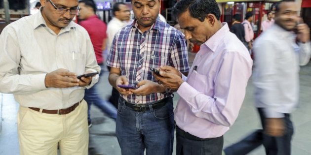 Passengers use smartphones at Mumbai Central railway station in Mumbai, India, on Friday, Jan. 22, 2016. Google Inc. in partnership with RailTel Corp. and Indian Railways today launched high speed WiFi at the station. They plan to roll out the service to more than 400 railway stations, covering 10 million passengers each day, according to chief executive officer Sundar Pichai. Photographer: Dhiraj Singh/Bloomberg via Getty Images