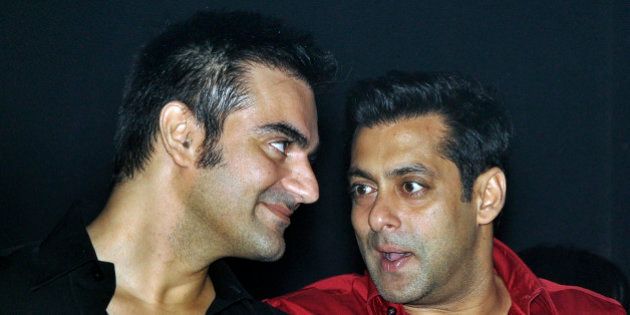 Indian Bollywood actor Salman Khan (R) speaks with his brother Arbaaz at the unveiling of 'Friday Moviez', a part of Twilight Entertainment in Mumbai late September 3, 2010. AFP PHOTO/STR (Photo credit should read STRDEL/AFP/Getty Images)