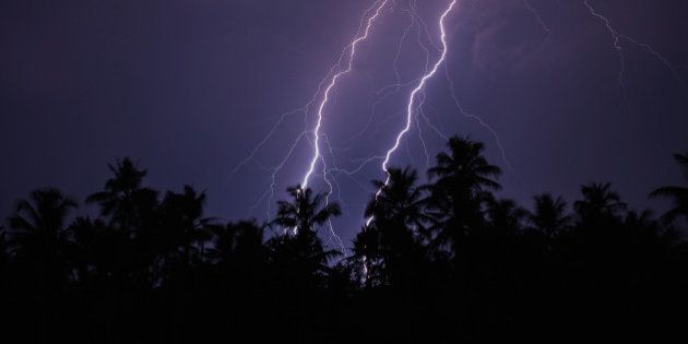 Twin lightning over the trees captured from Cochin, Kerala, India.