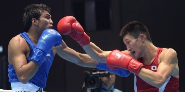 Japan's Masatsugu Kawachi (R) competes against India's Kumar Manoj (L) in the men's bosing light welter 64 kg preliminaries session 4 during the 2014 Asian Games in Incheon on September 25, 2014. AFP PHOTO / PORNCHAI KITTIWONGSAKUL (Photo credit should read PORNCHAI KITTIWONGSAKUL/AFP/Getty Images)
