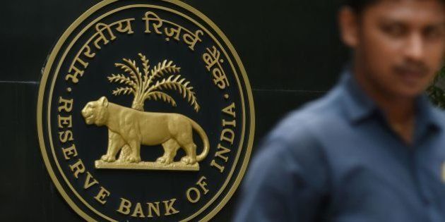 A pedestrian walks past India's central bank - Reserve Bank of India (RBI) logo in Mumbai on June 7, 2016.The Reserve Bank of India has held its key interest rate at a five-year low, citing inflationary fears in the world's fastest-growing major economy ahead of the imminent monsoon rains. In a widely expected move, RBI said it would keep the benchmark repo rate, the level at which it lends to commercial banks, at 6.5 percent. / AFP / INDRANIL MUKHERJEE (Photo credit should read INDRANIL MUKHERJEE/AFP/Getty Images)