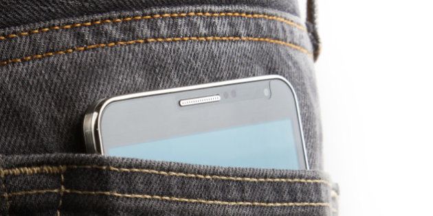 Black cell phone in jeans back pocket.