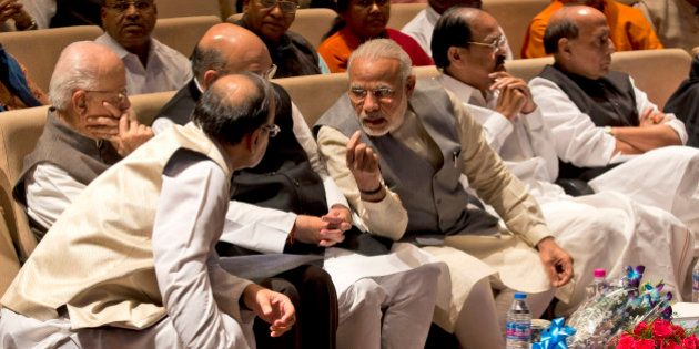 Indian Prime Minister Narendra Modi, third right, talks with Indian Finance Minister Arun Jaitley during a meeting of ruling National Democratic Alliance lawmakers in New Delhi, India, Tuesday, March 1, 2016. The meeting was to discuss attacks from the opposition on various issues and to thank Modi and Jaitley for presenting the federal budget. (AP Photo/Manish Swarup)