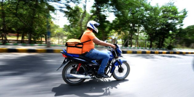GURGAON, INDIA - MAY 7: Aakash from Online Grocery Shopping portal Grofers going to deliver the consumables to the client on May 7, 2015 in Gurgaon, India. (Photo by Ramesh Pathania/Mint via Getty Images)