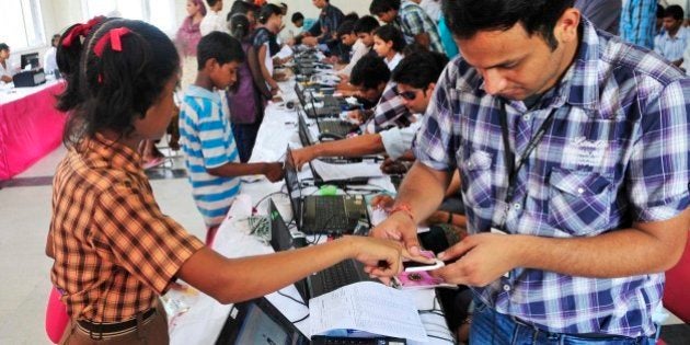 NEW DELHI, INDIA - JULY 24: People stand in queue during Aadhar card camp, pilot project for authentication of UID cards at Mayur Vihar, Phase 2, on July 24, 2012 in New Delhi, India. (Photo by Ramesh Pathania/Mint via Getty Images)