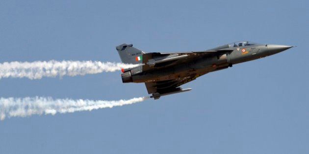 Tejas, an Indian Air Force light combat aircraft, leaves a trail of smoke as it flies on the final day of Aero India air show at Yelahanka air base in Bangalore, India, Sunday, Feb. 22, 2015. Aero India is a biennial event with flying demonstrations by stunt teams and militaries and commercial pavilions where aviation companies display their products and technology. (AP Photo/Aijaz Rahi)