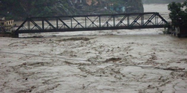 RUDRAPRAYAG, INDIA - JUNE 17: Several houses on the banks of Alaknanda River have fallen prey to the rise in water level post heavy rainfall on June 17, 2013 in Rudraprayag, India. 11 people died, nearly 50 were missing and thousands stranded in landslides set off by the incessant downpour in Uttarakhand. (Photo by Badri Nautiyal/Hindustan Times via Getty Images)