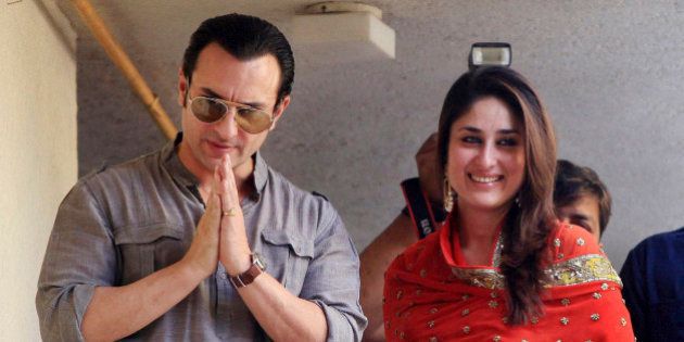 Bollywood stars, Saif Ali Khan, left, and Kareena Kapoor, step out on a balcony to greet waiting fans after getting married in Mumbai, India, Tuesday, Oct. 16, 2012. The Press Trust of India reported the couple married Tuesday in a small official ceremony in Khanâs house in Mumbai with a few friends and family members in attendance. (AP Photo)