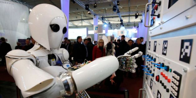 The humanoid robot AILA (artificial intelligence lightweight android) operates a switchboard during a demonstration by the German research centre for artificial intelligence at the CeBit computer fair in Hanover March, 5, 2013. The biggest fair of its kind open its doors to the public on March 5 and will run till March 9, 2013. REUTERS/Fabrizio Bensch (GERMANY - Tags: BUSINESS SCIENCE TECHNOLOGY)