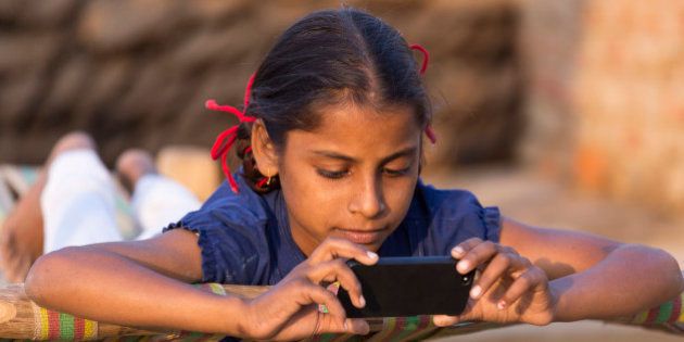 India, Uttar Pradesh, Agra, young girl loooking at smartphone.