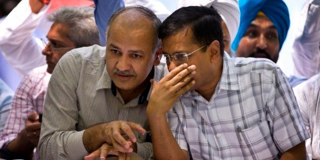 Delhi Chief Minister Arvind Kejriwal, right, speaks to his deputy Manish Sisodia at a farmerâs rally near the Indian parliament in New Delhi, India, Wednesday, April 22, 2015. Indian farmers and the opposition parties are protesting against a government plan to ease rules for obtaining land for industry and development projects. (AP Photo/Saurabh Das)