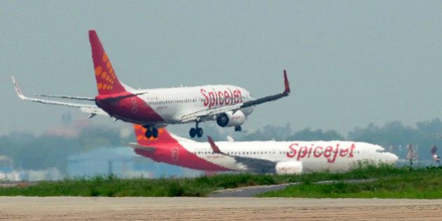 Aircraft from Spicejet jostle for space on a runway at Indira Gandhi International Airport in New Delhi on July 13, 2011. Boeing have projected India would require about 1,300 commercial planes worth USD150 billion in the next two decades to meet the demands of its growing and more affluent population. The forecast from the world's largest aerospace company was 15 percent higher than projections of 1,150 planes for USD130 billion Boeing announced in August 2010 for India's civil aviation market. AFP PHOTO/RAVEENDRAN (Photo credit should read RAVEENDRAN/AFP/Getty Images)