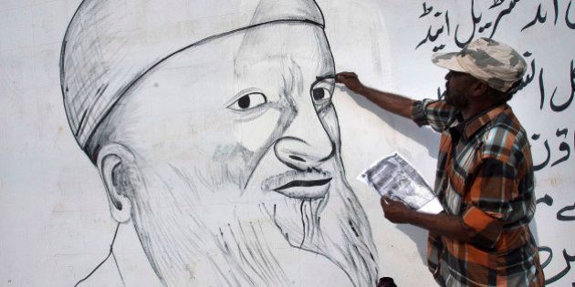 A painter makes a mural of Pakistan's greatest humanitarian worker Abdul Sattar Edhi to pay tribute to him, in Karachi, Pakistan, Tuesday, June 28, 2016. Pakistan's greatest humanitarian worker Edhi, who is suffering from acute kidney disease, is very ill these days and visits hospital several times a week for dialysis. (AP Photo/Shakil Adil)