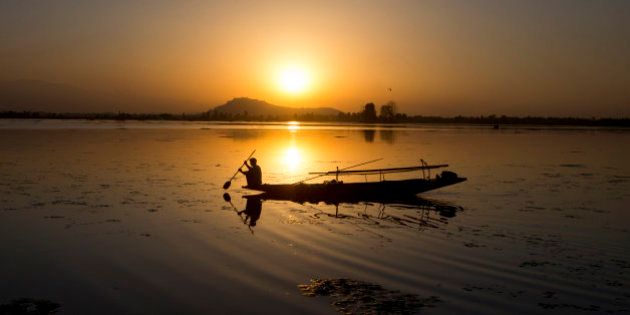 A Kashmiri fisherman rows his Shikara, or traditional boat, during sunset at the Dal Lake in Srinagar, Indian controlled Kashmir, Saturday, Aug. 29, 2015. Nestled in the Himalayan mountains and known for its beautiful lakes and saucer-shaped valleys, the Indian portion of Kashmir, is also one of the most militarized places on earth. (AP Photo/Dar Yasin)