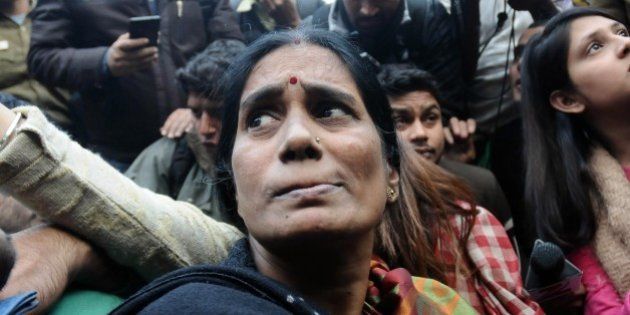 NEW DELHI, INDIA - DECEMBER 21: The mother of Indian gang-rape victim 'Nirbhaya' (C) talks to the media as she attends a rally held to protest the release of a juvenile rapist in New Delhi on December 21, 2015. India's Supreme Court rejected an appeal against the release of the youngest convict in an infamous fatal gang-rape, sparking fury from the victim's parents who said the ruling was a betrayal. (Photo by Vinod Singh/Anadolu Agency/Getty Images)