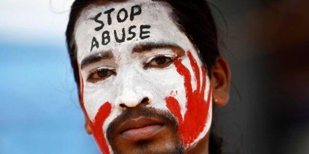An Indian protester with a slogan painted on his face participates in a demonstration to protest against police inaction after a six-year-old was allegedly raped in a school, in Bangalore, India, Sunday, July 20, 2014. More than a hundred protesters gathered Sunday and demanded that police arrest those involved in the July 2 incident, which was reported only this past week. The rape has raised questions about the safety of India's schoolchildren and sparked nationwide outrage over rampant sexual violence against girls and women. (AP Photo/Aijaz Rahi)
