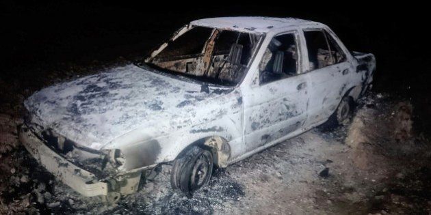 A burned down car remains at the crime scene where six people were executed by gunmen in Tetitlan de Las Limas, Chilapa, Guerrero state, Mexico on November 10, 2015. Six people were killed in a violent Mexican town of Guerrero (south), five of the victims belonged to the family of a controversial former chief of police and including two children aged seven and one years and their mother, said Tuesday the state police .This brutal murder occurred on Monday joined the Sunday day of violence in Guerrero, where 16 people were killed, 12 in a clash in a cockfight and four in a sports after a football match. AFP PHOTO/ STR (Photo credit should read STR/AFP/Getty Images)