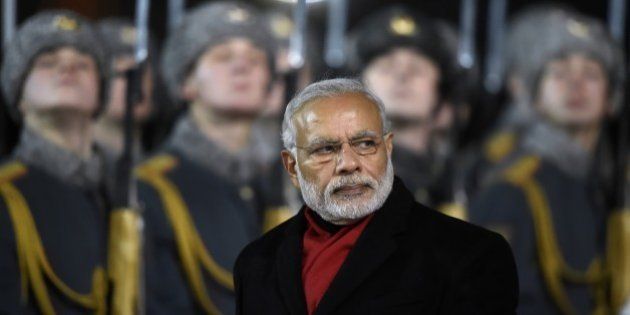 India's Prime Minister Narendra Modi reviews an honor guard during a welcoming ceremony at Moscow's Vnukovo II airport on December 23, 2015. Modi is on a two-day official visit to Russia. AFP PHOTO / ALEXANDER NEMENOV / AFP / ALEXANDER NEMENOV (Photo credit should read ALEXANDER NEMENOV/AFP/Getty Images)