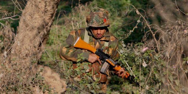 An Indian army soldier is seen during a search operation in a forest area outside the Pathankot air force base in Pathankot, India, Sunday, Jan. 3, 2016. Combing operations to secure the Indian air force base where a group of militants started an attack before dawn on Saturday were continuing late Sunday morning. (AP Photo/Channi Anand)