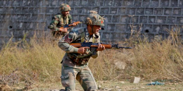 Indian army soldiers conduct a search operation in a forest area outside the Pathankot air force base in Pathankot, India, Sunday, Jan. 3, 2016. Combing operations to secure the Indian air force base where a group of militants started an attack before dawn on Saturday were continuing late Sunday morning. (AP Photo/Channi Anand)